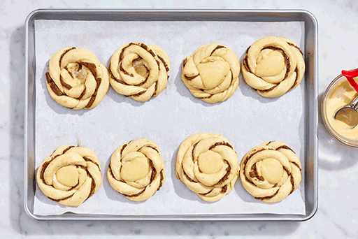 Sunshine buns being filled with custard before baking.