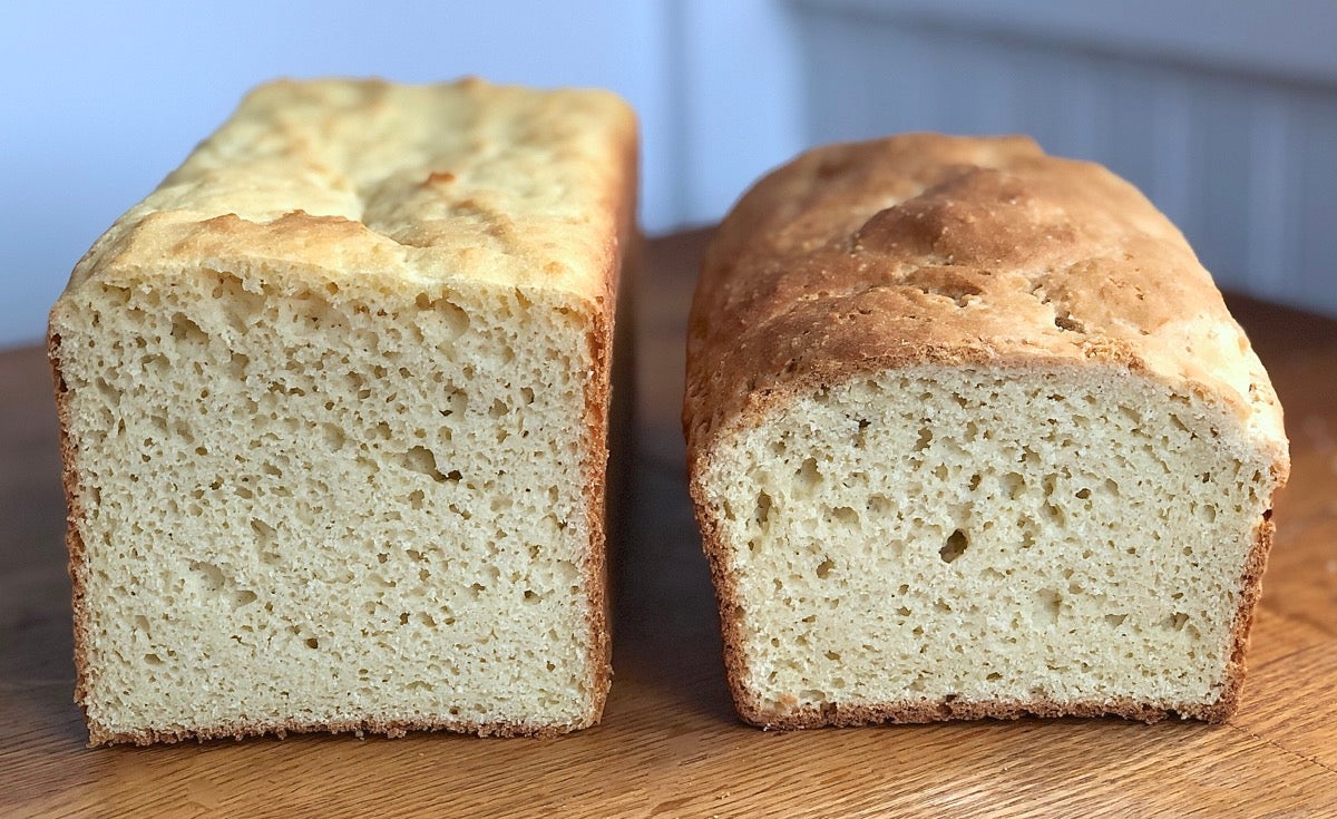 Two loaves of gluten-free sandwich bread baked in different pans, side by side, for height comparison