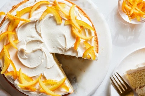 A layer cake garnished with candied oranges and a cream filling