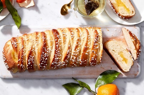 A loaf of braided bread filled with lemon curd and cut into slices
