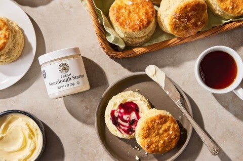 Sourdough Discard Buttermilk Biscuits on a plate with a cup of coffee