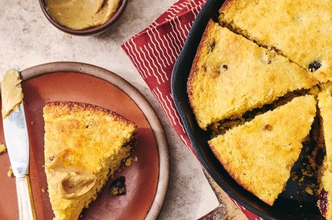 Cranberry Cornbread sliced and in a cast iron pan