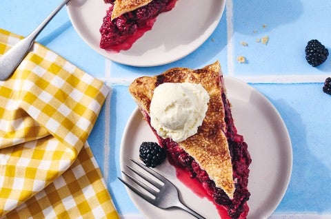 A slice of Gingery Blackberry Pie on a plate