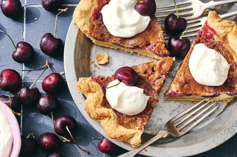 3 slices of Cherry-Vanilla Cream Pie in a pie dish topped with whipped cream