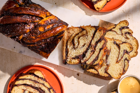 Chocolate Sourdough Babka sliced and arranged with other elements on a counter and seen from above.