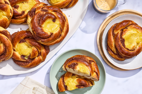 Sunshine buns on plates and arranged on a counter, seen from above.