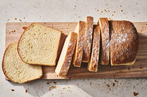 Sliced sandwich bread on a cutting board.