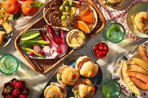 Hot Party Sandwiches on an elaborate table with other vegetables, dips, and lunch items