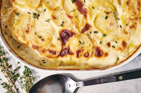 Scalloped Potatoes fresh out of the oven in a stoneware pan seen from above