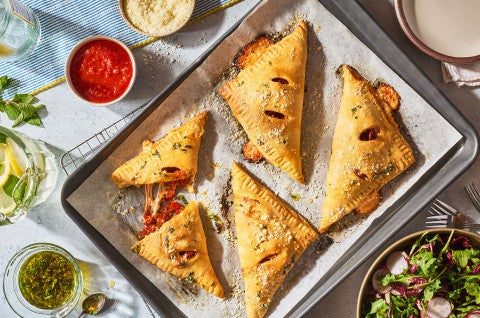Flaky Puff Crust Pizza Turnovers on a baking sheet