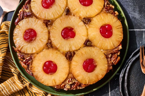 Pineapple Upside Down Cake seen from above with caremelized pineapple rings filled with maraschino cherries