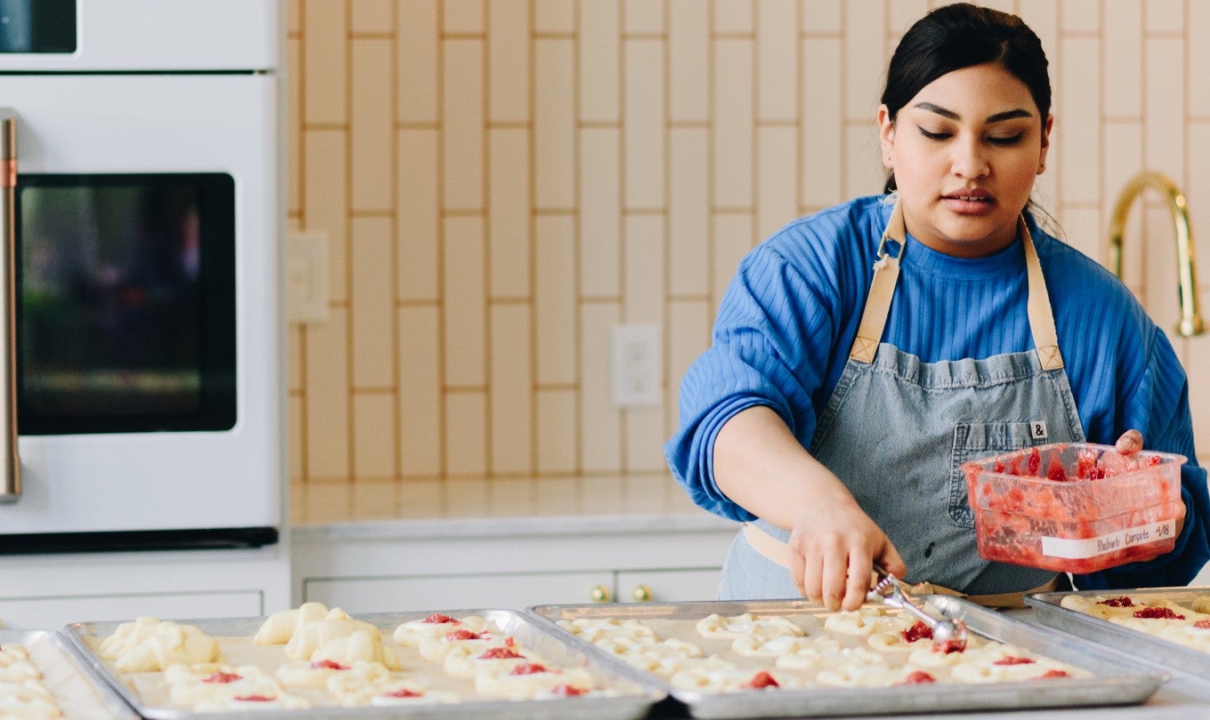 A baker preparing lots of cookies