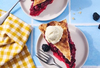 A slice of Gingery Blackberry Pie on a plate