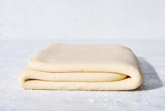 Dough for Classic Puff Pastry (Pâte Feuilletée) on a table