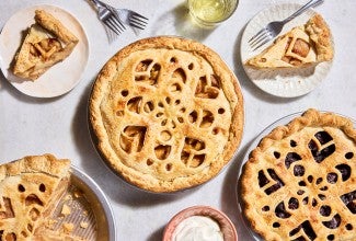 Three Apple Pie with Make-Ahead Filling in pie pans and two slices on plates