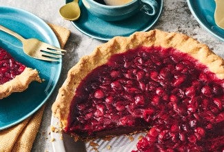 Cranberry-Fudge Pie in a pie tin with a slice removed.