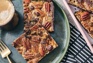 Two slices of Slab Chocolate Pecan Pie on a plate.