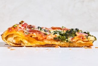 Sideview of a slice of Flaky Puff Crust Pizza