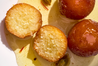 Gulab Jamun sliced and showing a cross-section of the treat.