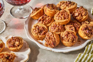 Pecan Tassies arranged on a plate