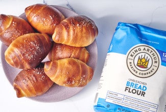 Bag of bread flour next to a plate of salt bread