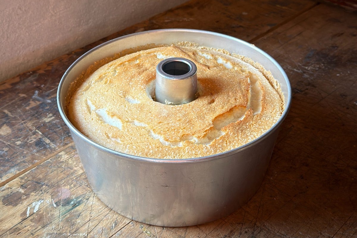 Angel food cake cooled upside-down, still in its pan 