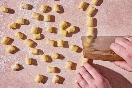 Shaping ricotta gnocchi pasta dough with a bench knife