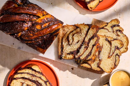 Chocolate Sourdough Babka sliced and arranged with other elements on a counter and seen from above.