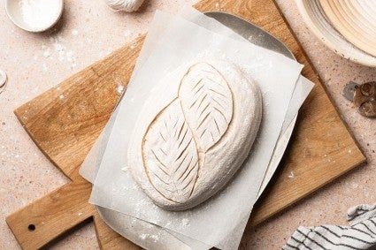 Sourdough bread loaf with a leaf design scored into it 