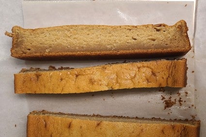 Slices of cake with thin layer of dense gumminess at the bottom 
