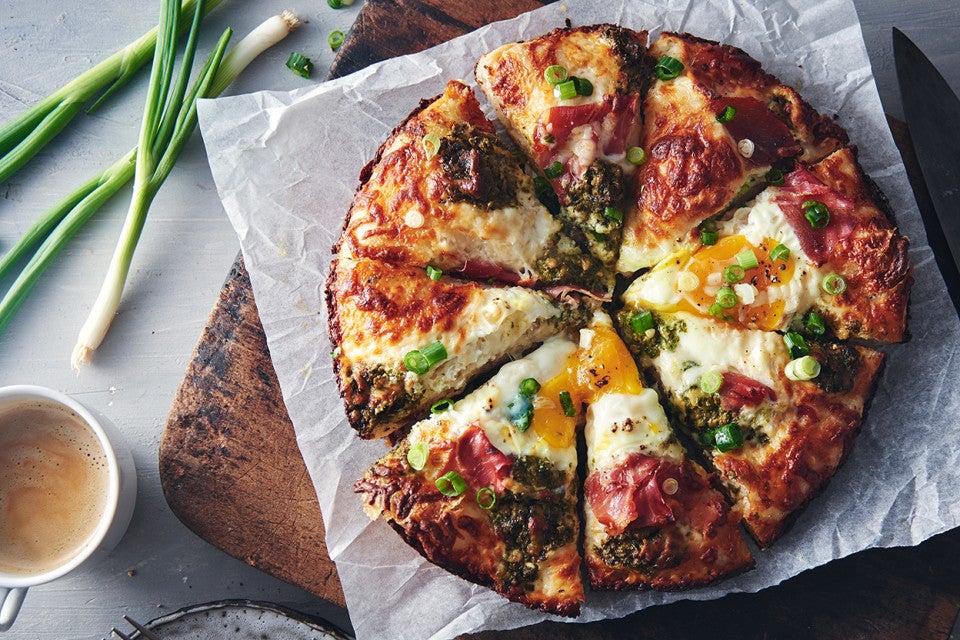 Breakfast pizza with “green eggs and ham”