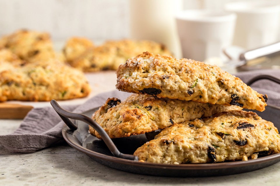 A small plate with a stack of zucchini scones, ready to be served