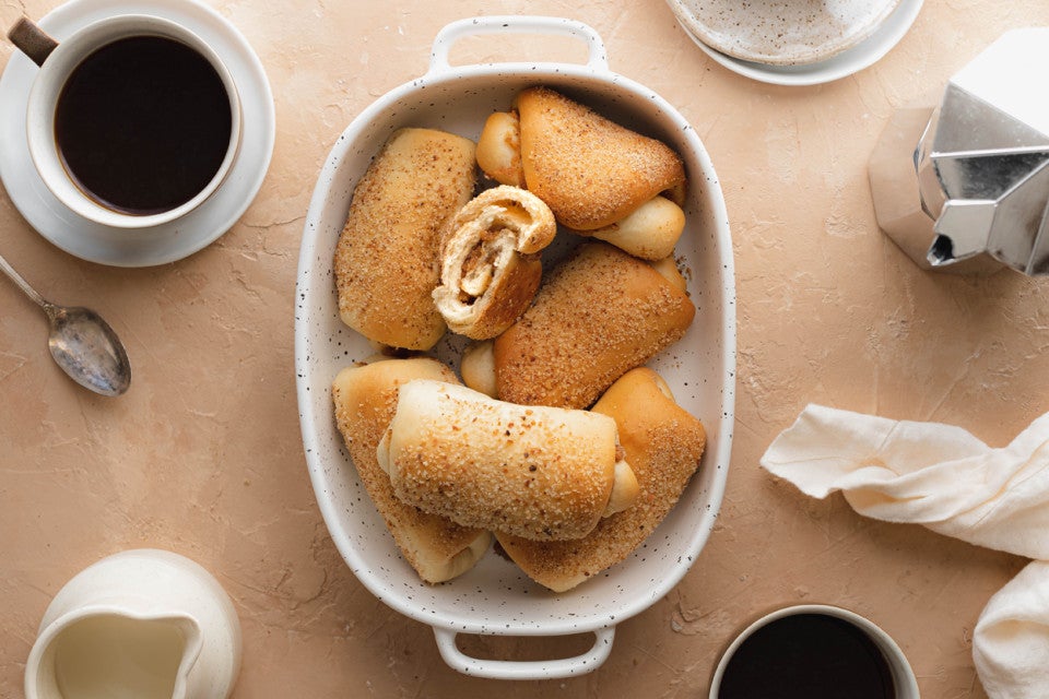 A dish full of senorita bread showing the swirled filling inside