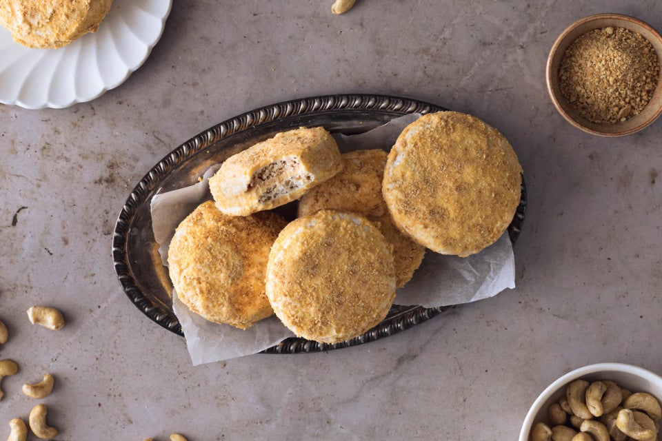 A stack of Filipino cookies, made with buttercream sandwiched between two cashew-meringue wafers coated with cookie crumbs