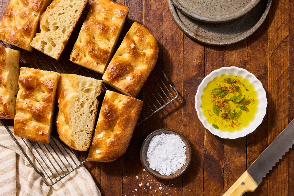 Sourdough Focaccia on a cooling rack with olive oil and salt