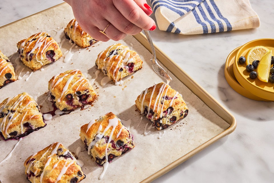 Blueberry Biscuits with Lemon Glaze being applied