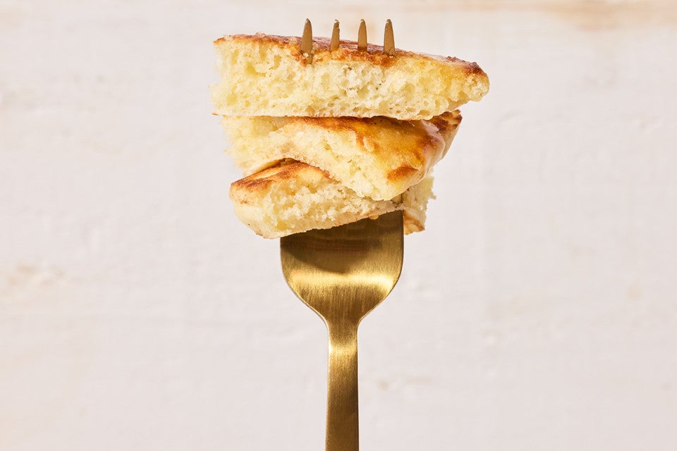 Easy Buttermilk Pancakes stacked up on a fork