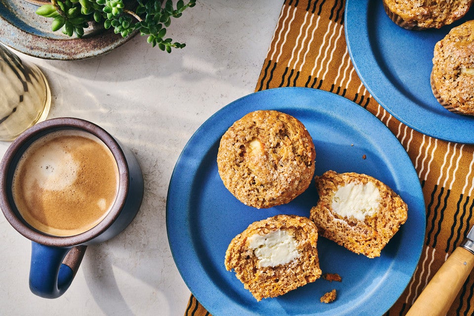 Cream Cheese Carrot Cake Muffins on a plate with a cup of coffee