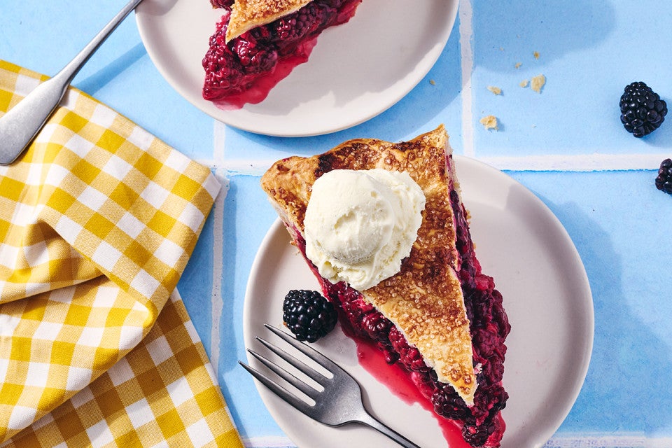 A slice of Gingery Blackberry Pie on a plate