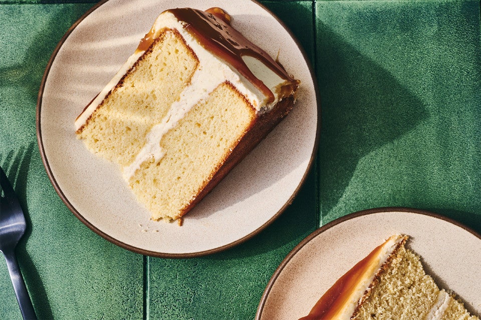 Two slices of Caramel Layer Cake with Brown Butter Frosting on a plate