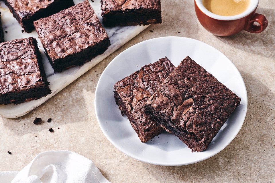 Gluten-Free Brownies on a plate with some coffee