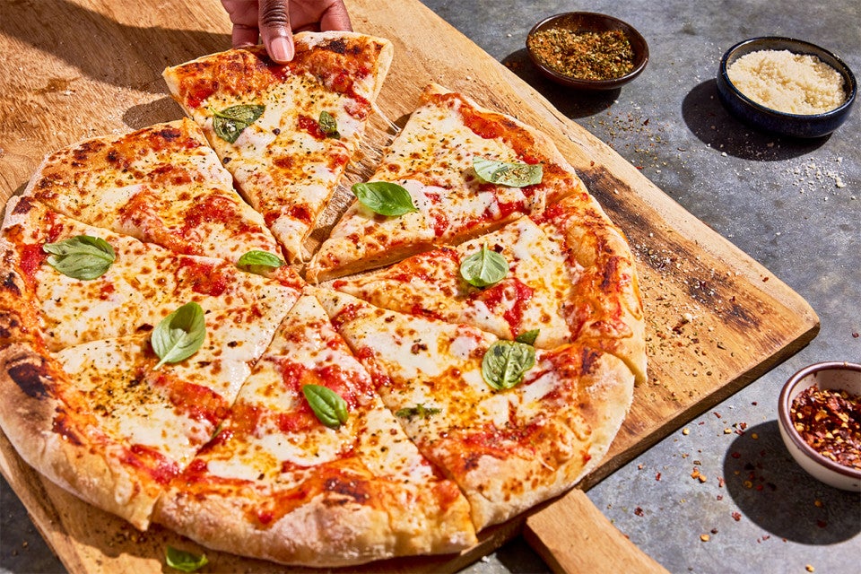 No-Knead Pizza Crust sliced on a cutting board