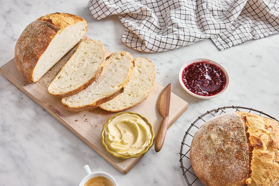 Extra-Tangy Sourdough Bread sliced on a cutting board