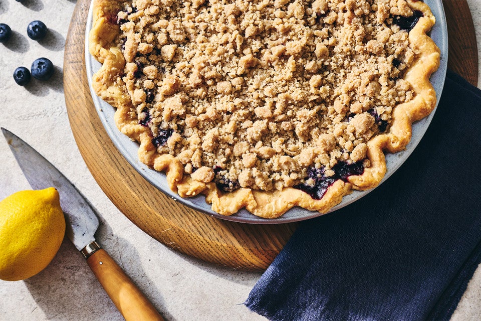 Lemon-Blueberry Streusel Pie in a piece dish on a cutting board