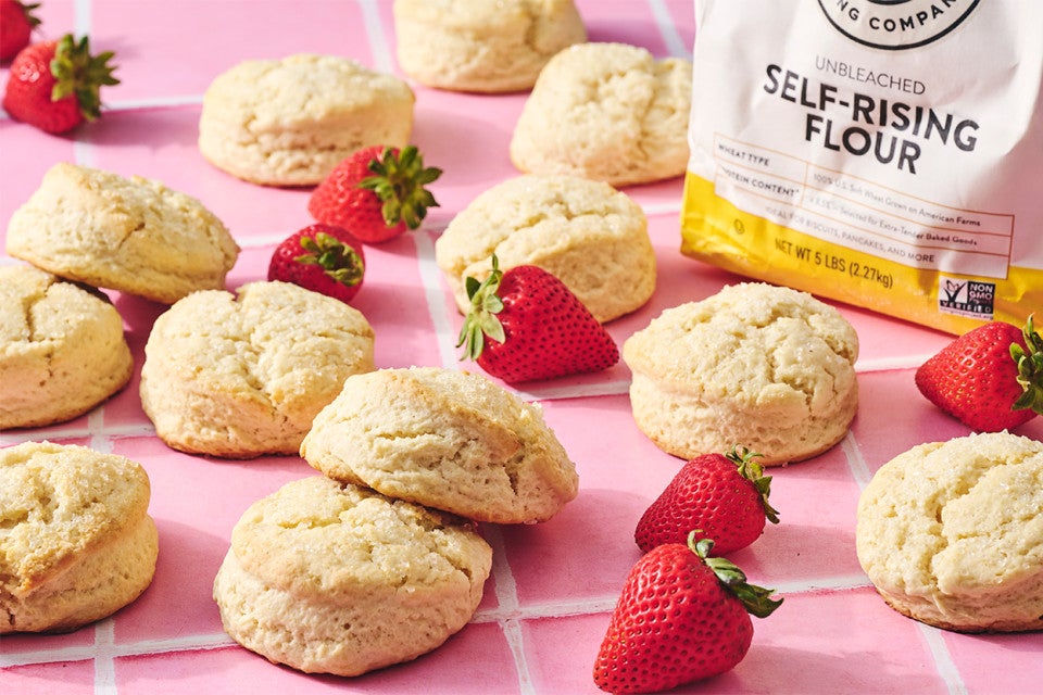 Self-Rising Cream Biscuits on a counter with strawberries