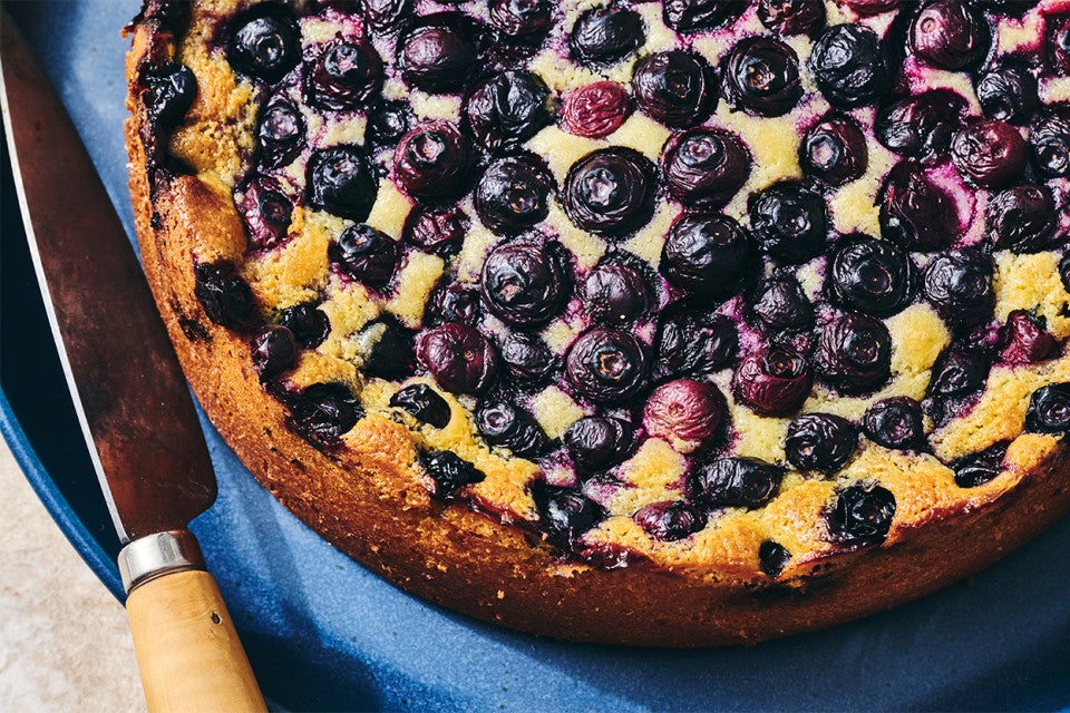 An uncut Blueberry Breakfast Cake on a plate