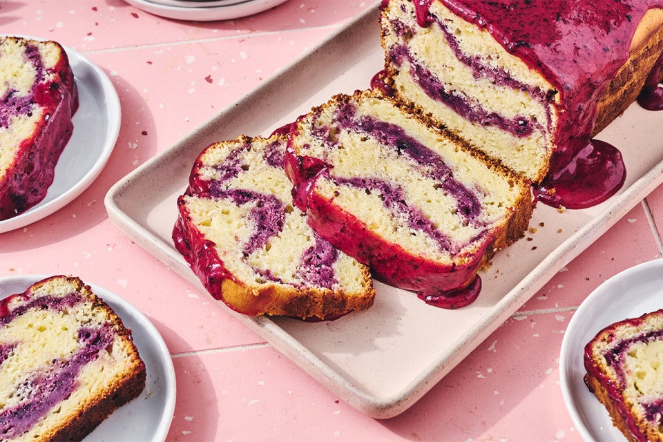 A Lemon Blueberry Loaf Cake with slices cut from it