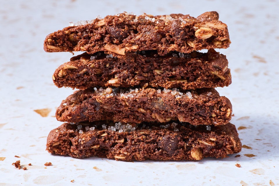 Vegan and gluten-free chocolate cookies shown sliced and stacked from the side.