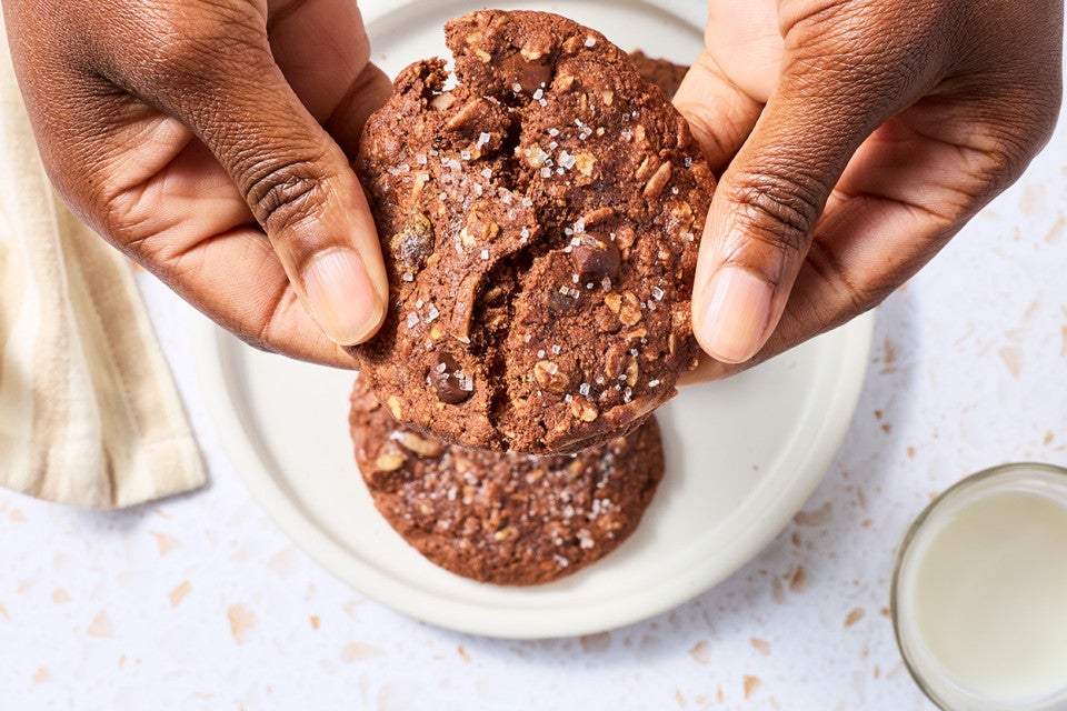 Breaking a Chocolate Lactation Cookie to show the soft texture.