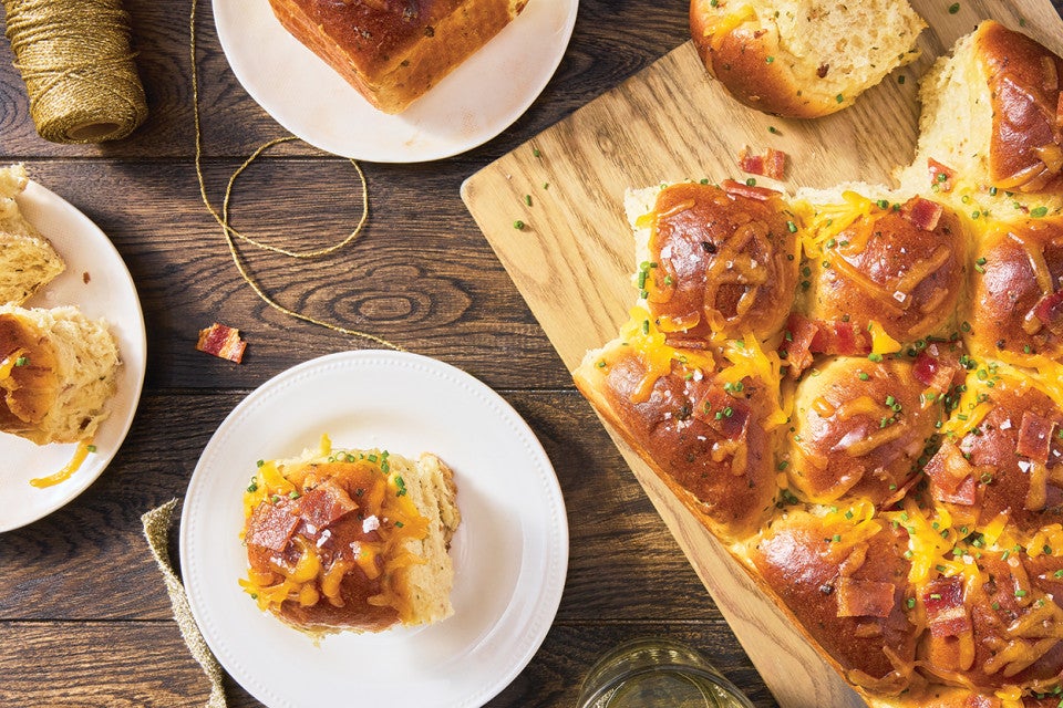 Loaded Baked Potato Dinner Rolls on a cutting board